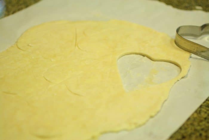 pie dough rolled and cut with a heart shaped cutter