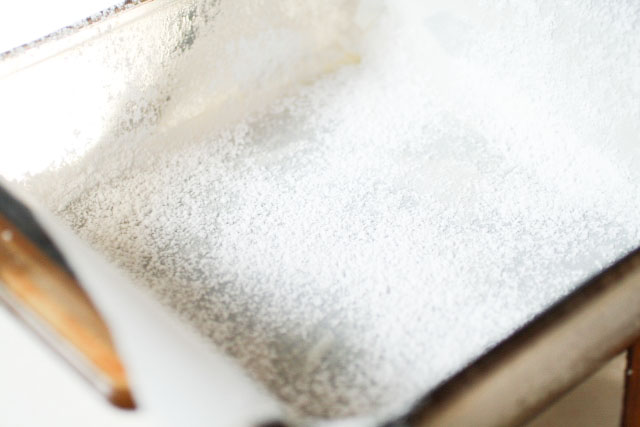 square baking pan dusted with icing sugar
