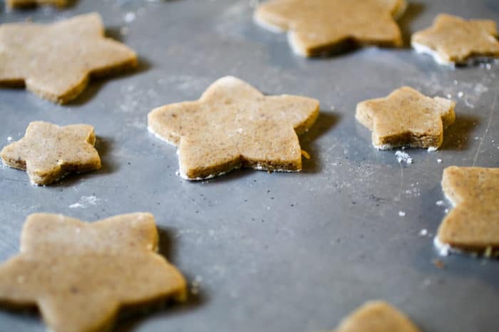 Brown Butter Spice Cutout Cookies star cookies on a cookie sheet.