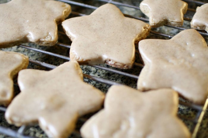 iced star shape cookies on a cooling rack.