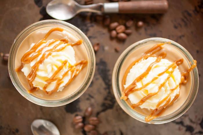 Homemade Dulce de Leche Pudding in 2 jars on a tray, with coffee beans 
