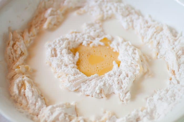 ingredients for cheese waffles in a white bowl