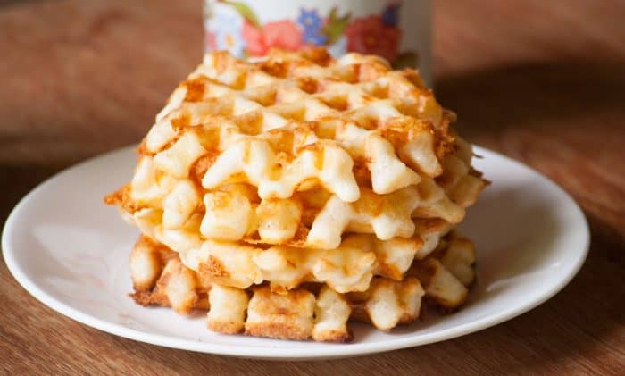 4 cheese waffles stuck on top of each other on a white plate