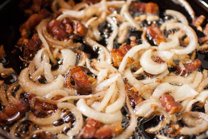 onions and bacon cooking on a pan