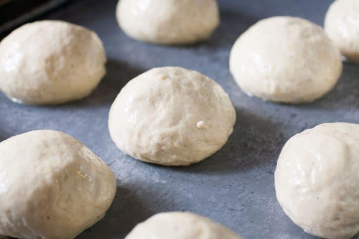 Semlor buns on a baking tray