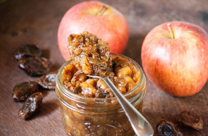 Homemade Apple and Date Chutney in a jar with 2 apples behind it