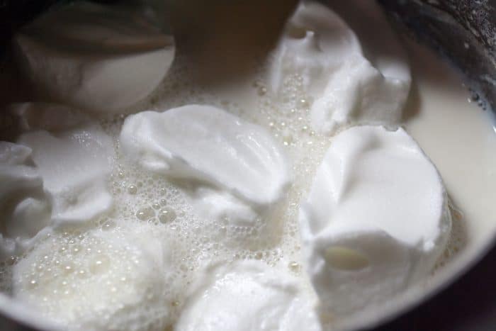 meringues simmering in milk