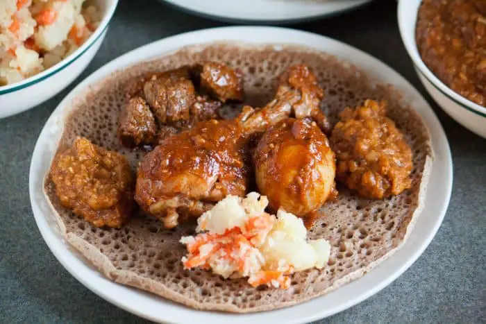 plate with injera, lentils and beef