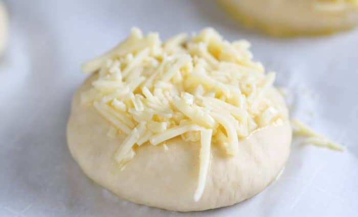 unbaked rolls with cheesy crust