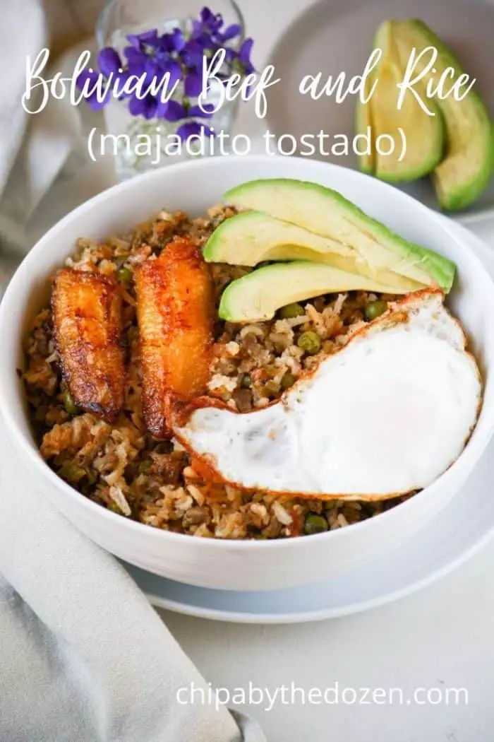 fried rice in a bowl with plantain, fried egg, and avocado