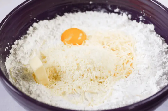cassava starch, cheese, egg and butter in a bowl