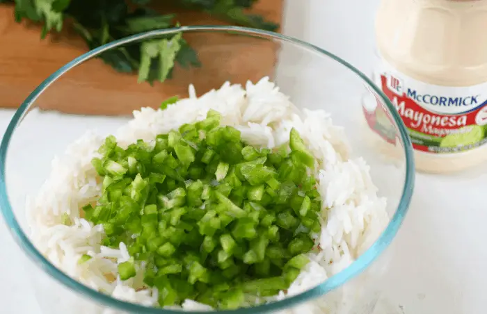 bowl with rice, green peppers, mayo on the side