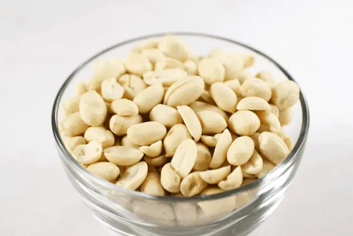 raw peanuts in a clear bowl