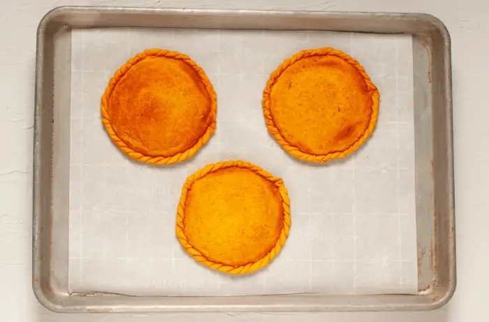 3 empanadas on tray, baked