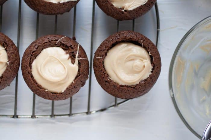 brownie cups with peanut butter filling on a cooling rack