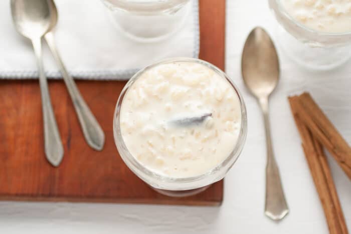 rice pudding in a glass, spoons around it