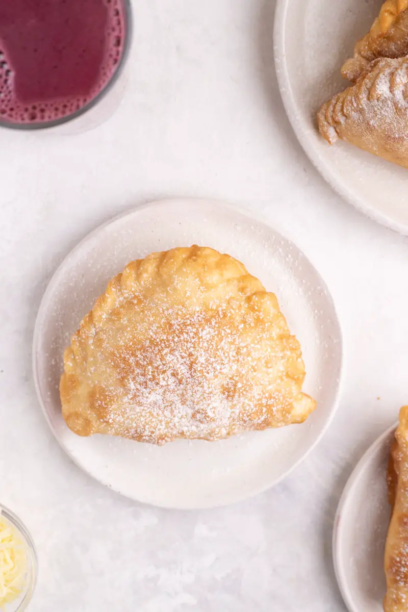 plate with fried empanada and api