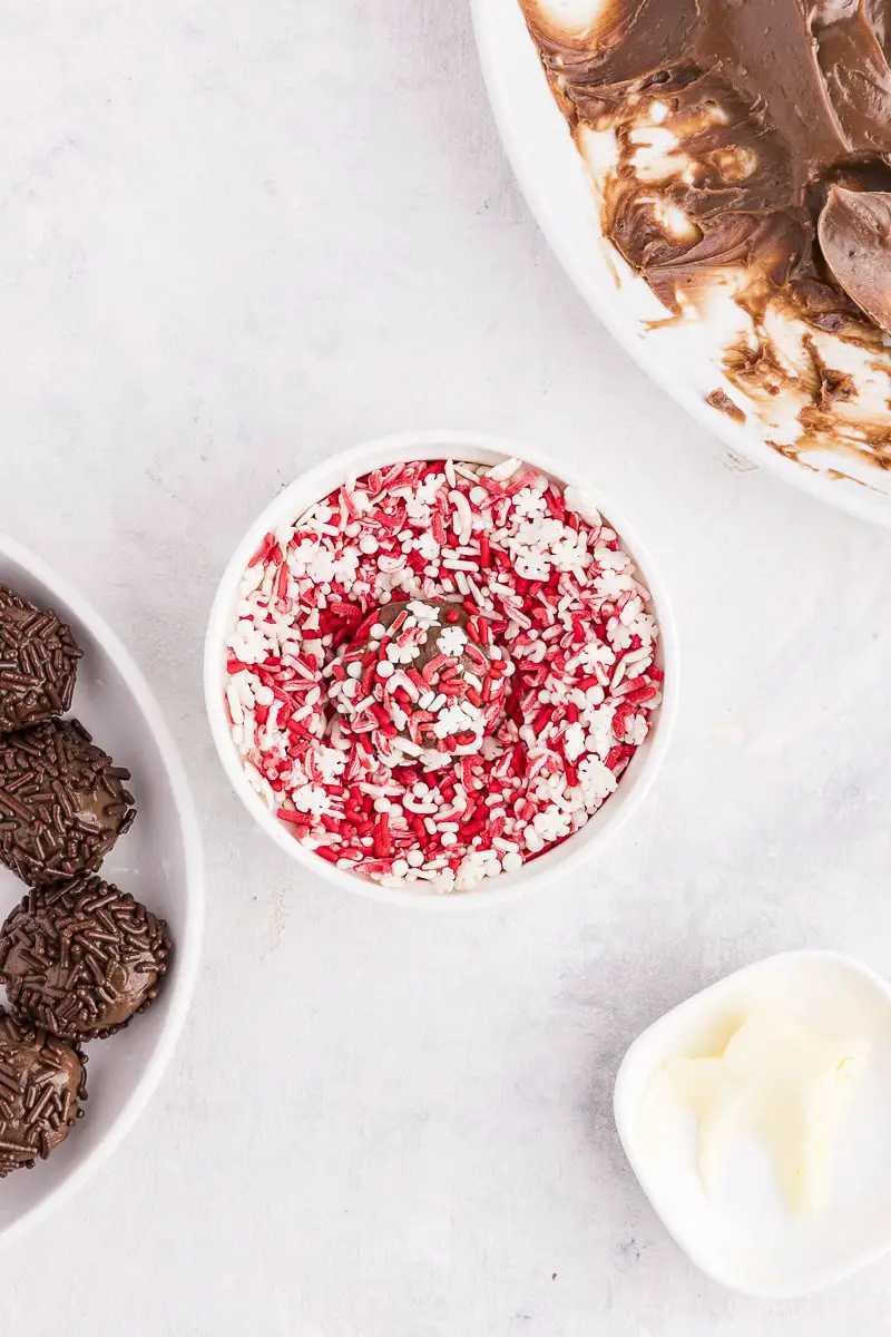 small bowl with peppermint sprinkles and a truffle